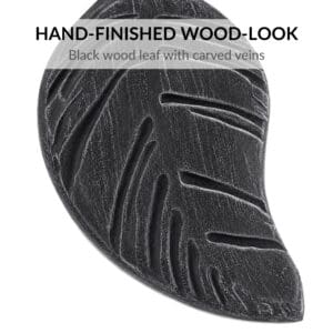 Close-up of black brushed wood-look leaf tieback with gray highlights and carved veins