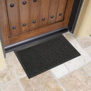 Black door mat fitting easily under front door threshold