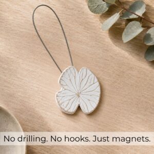 Flat-lay bois: White water lily magnetic curtain tieback on light wood with eucalyptus, no drilling no hooks just magnets
