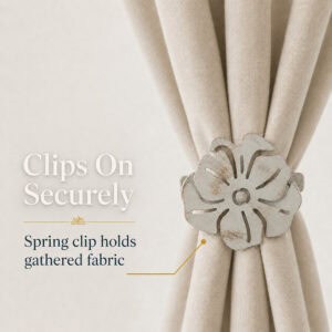 Spring clip curtain tieback holding gathered curtain fabric