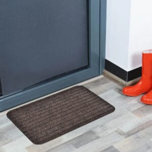 Brown indoor door mat placed in front of a modern entry door