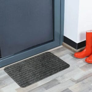 Gray indoor door mat placed in front of a modern entry door
