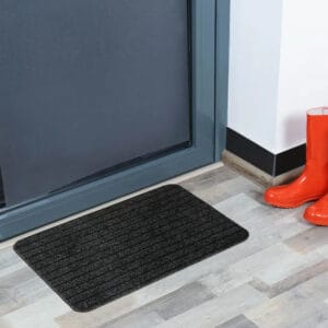 Anthracite gray indoor door mat placed in front of a modern entry door