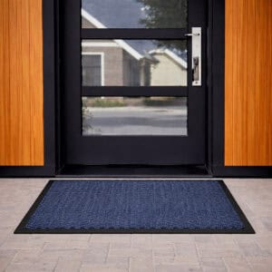 Blue door mat in front of modern glass exterior door