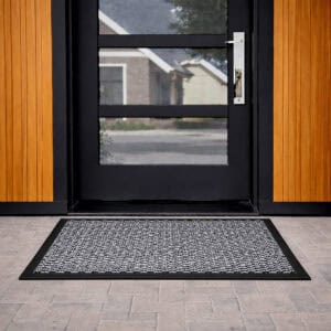 Gray door mat in front of modern glass exterior door