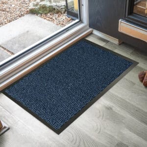 Blue indoor outdoor doormat placed by sliding door on wood floor