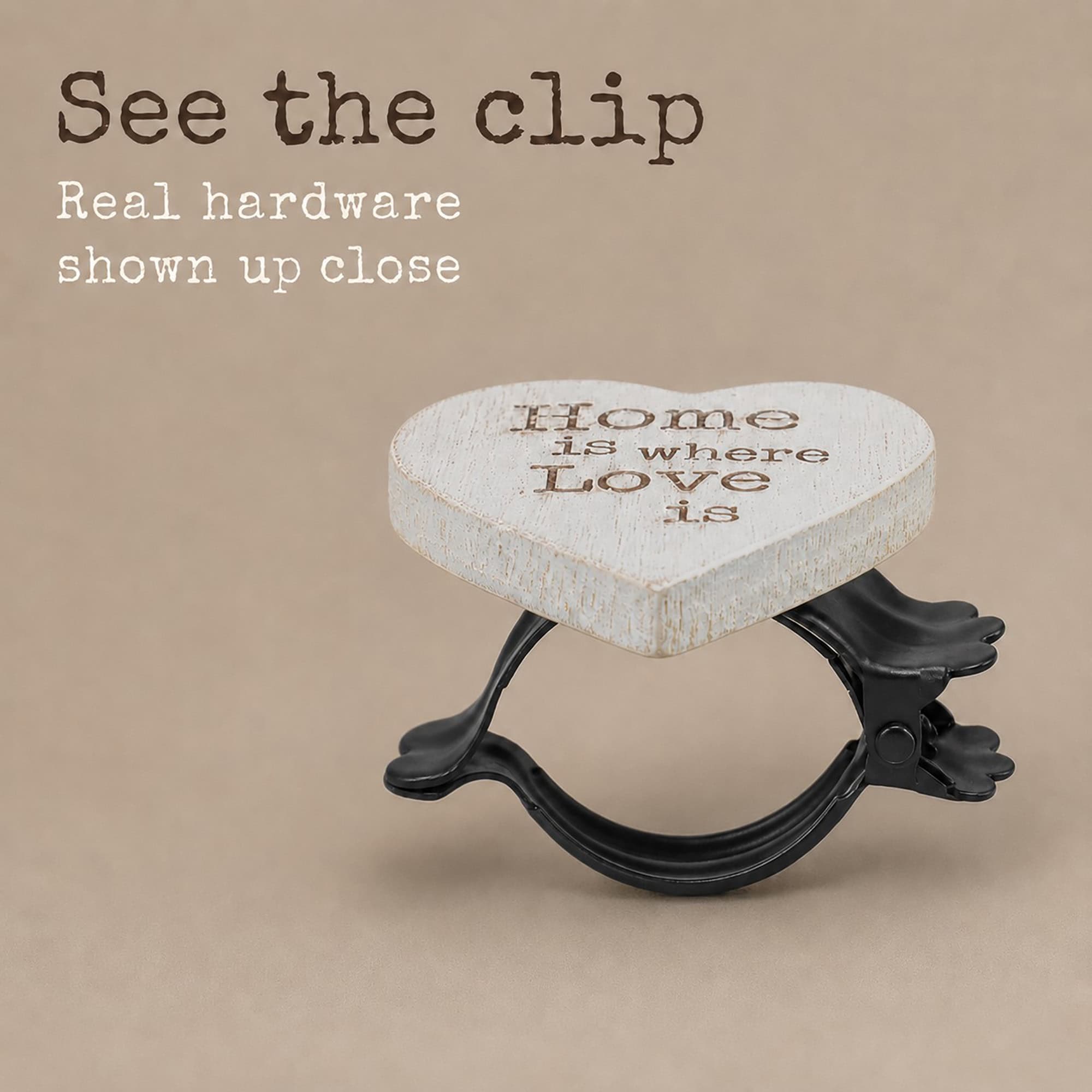 5- Close-up of the black metal spring clip hardware behind the wooden heart curtain tieback