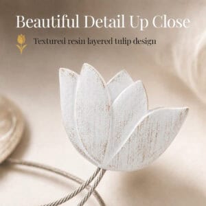 texture detail: Macro view of the layered resin tulip in white, showing the textured petals and brushed finish of the curtain tieback flower.