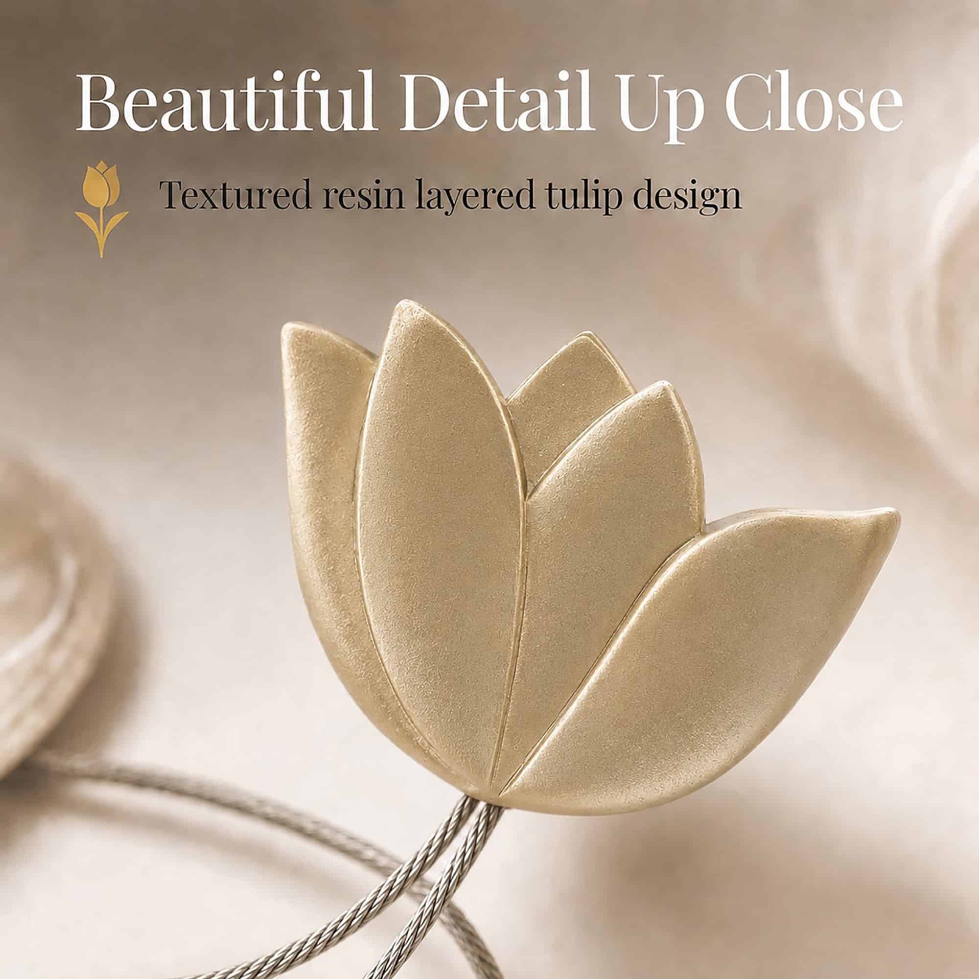 texture detail: Macro view of the layered resin tulip in gold, showing the textured petals and brushed finish of the curtain tieback flower.