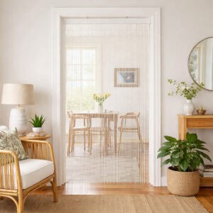 White bamboo bead curtain used as doorway divider in bright dining room