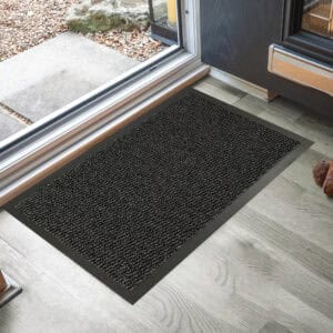 Black door mat in front of door