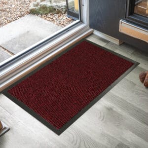 Red burgundy outdoor front door mat on stone entry for heavy traffic use