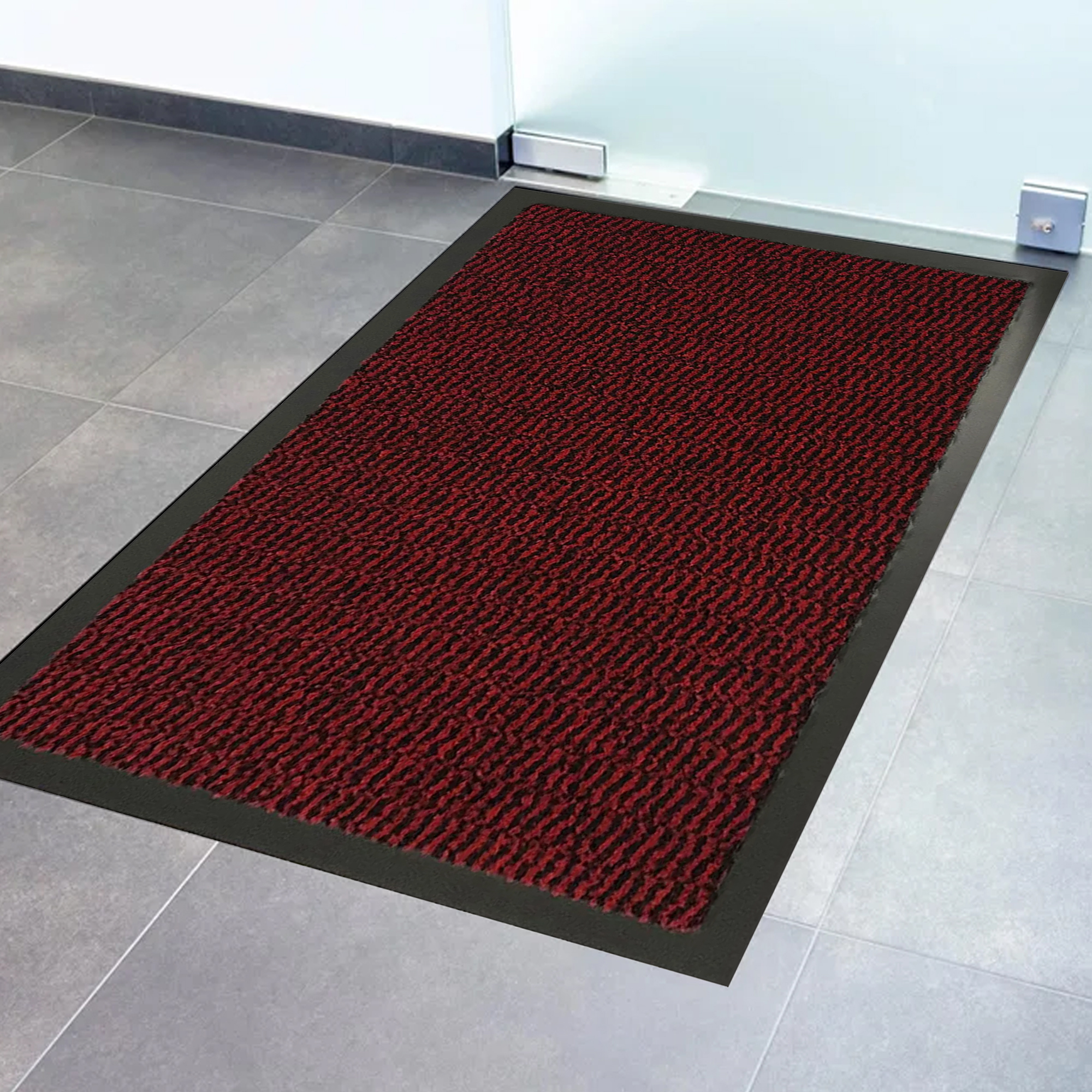 Close-up of red textured door mat surface with black non-slip border