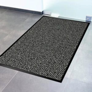 Close-up of gray textured door mat surface with black non-slip border