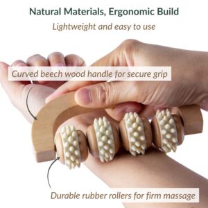 Close-up of hands holding massage roller showing curved beech wood handle for secure grip and durable rubber rollers for firm massage