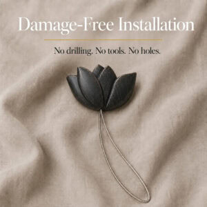 installation: Black resin tulip tieback resting on soft linen with its twisted cable loop, illustrating tool free installation with no drilling or holes.