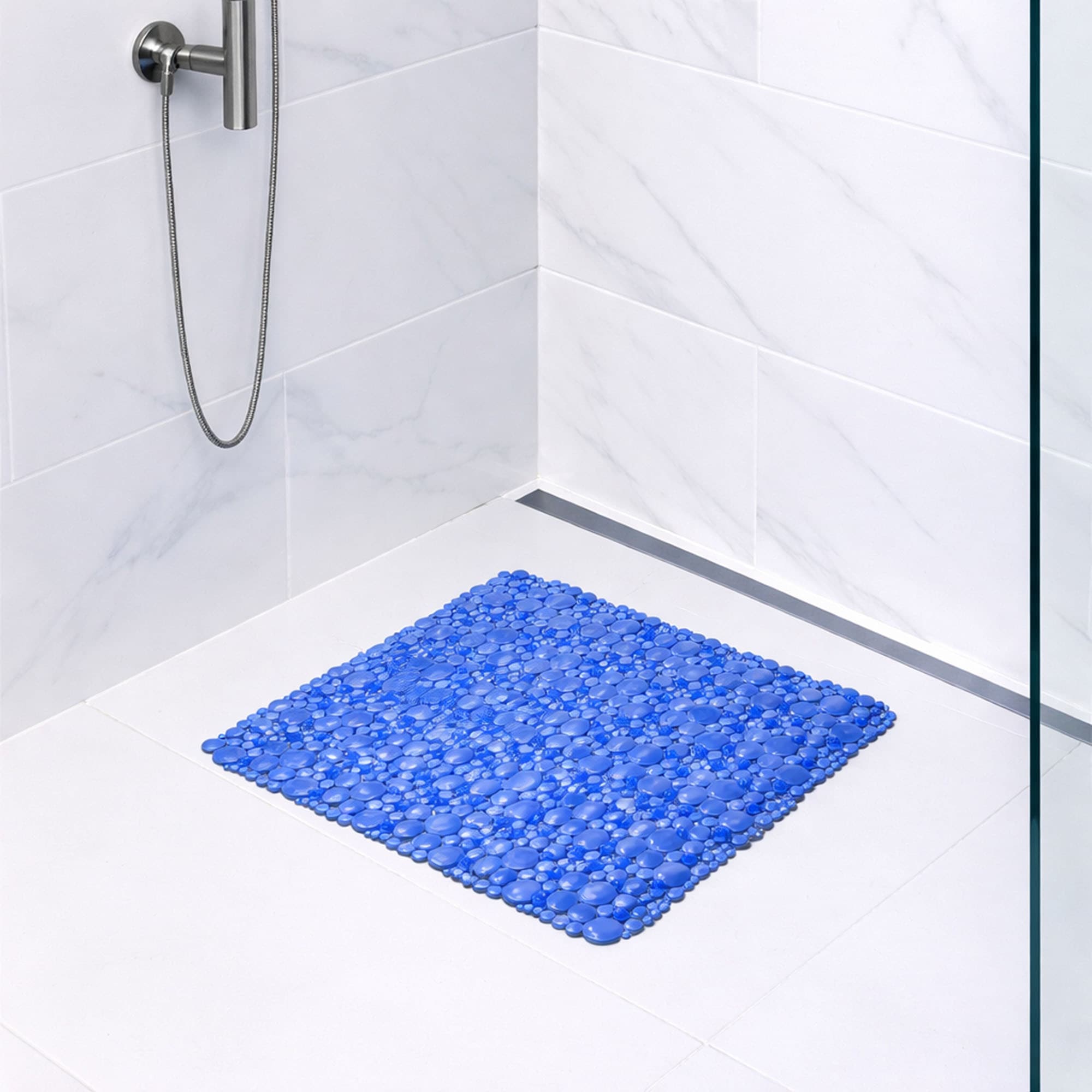 Navy blue bubble-pattern shower mat on tile shower floor