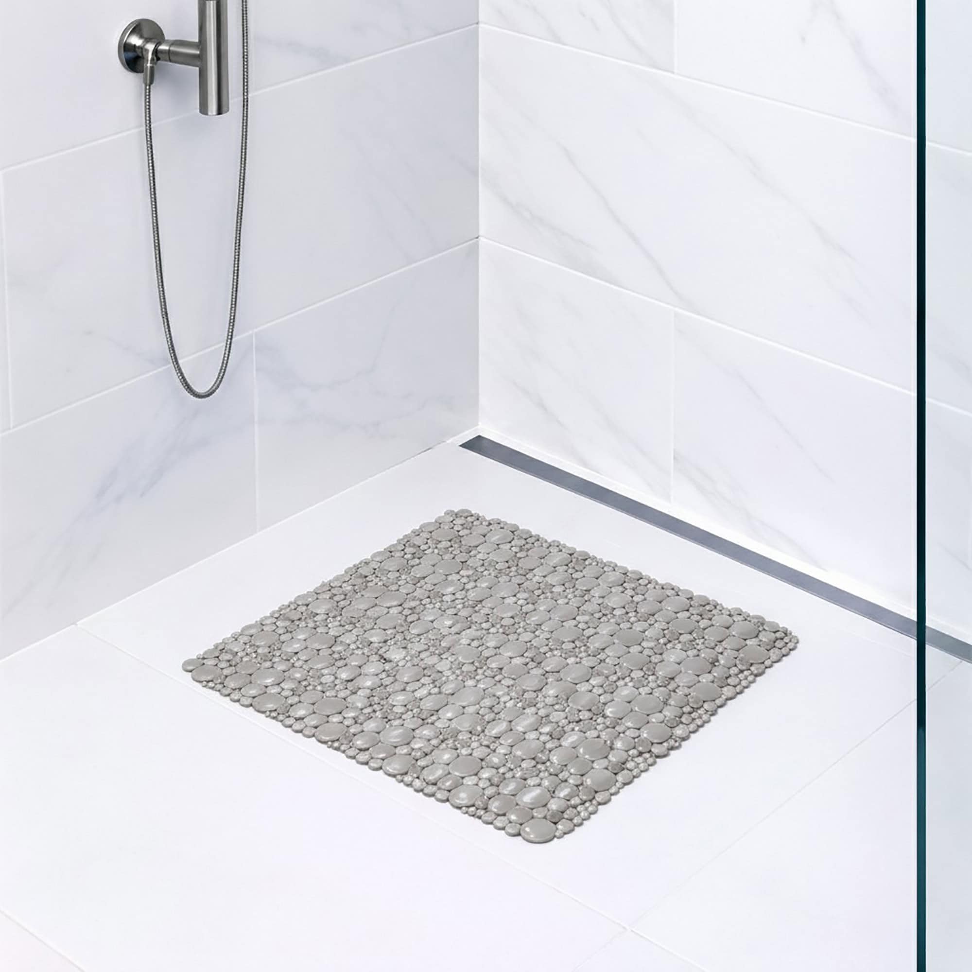Taupe bubble-pattern shower mat on tile shower floor
