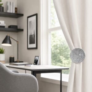 Chrome round curtain tieback clip in an office setting