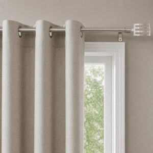 Grey grommet curtains hanging from the silver adjustable curtain rod beside a window
