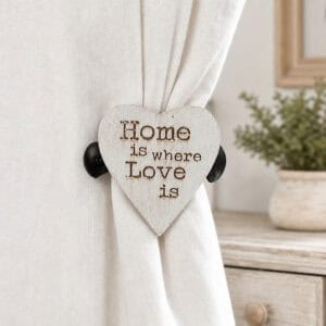 8- Rustic whitewashed heart curtain holdback gathering a natural linen curtain beside a wooden dresser and greenery