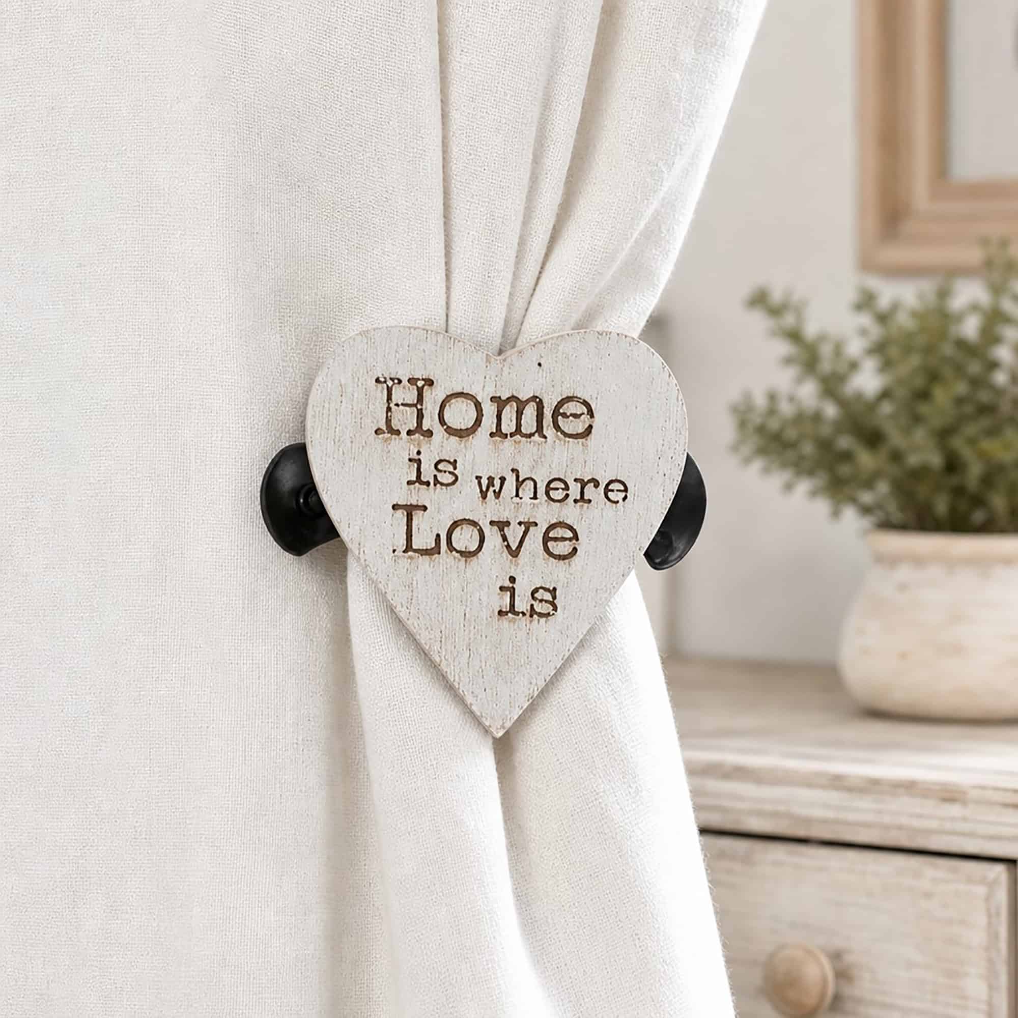 8- Rustic whitewashed heart curtain holdback gathering a natural linen curtain beside a wooden dresser and greenery