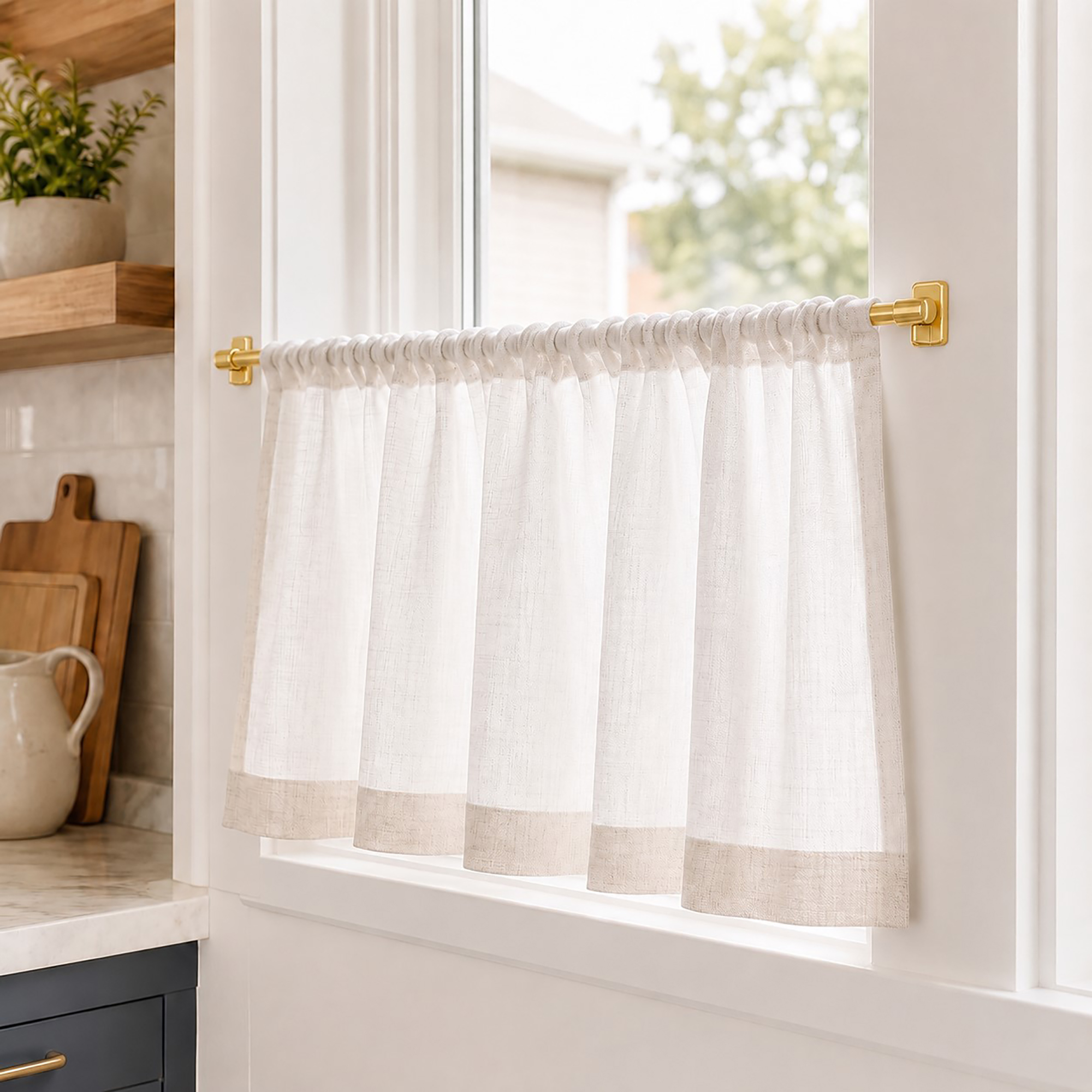 Sheer cafe curtain on an adhesive sash rod in a bright farmhouse kitchen window