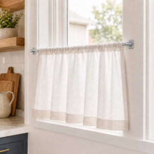 Sheer cafe curtain on an adhesive sash rod in a bright farmhouse kitchen window
