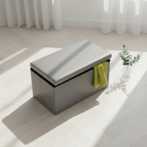"Gray faux leather folding storage ottoman bench with open lid and yellow towel in sunlit room"
