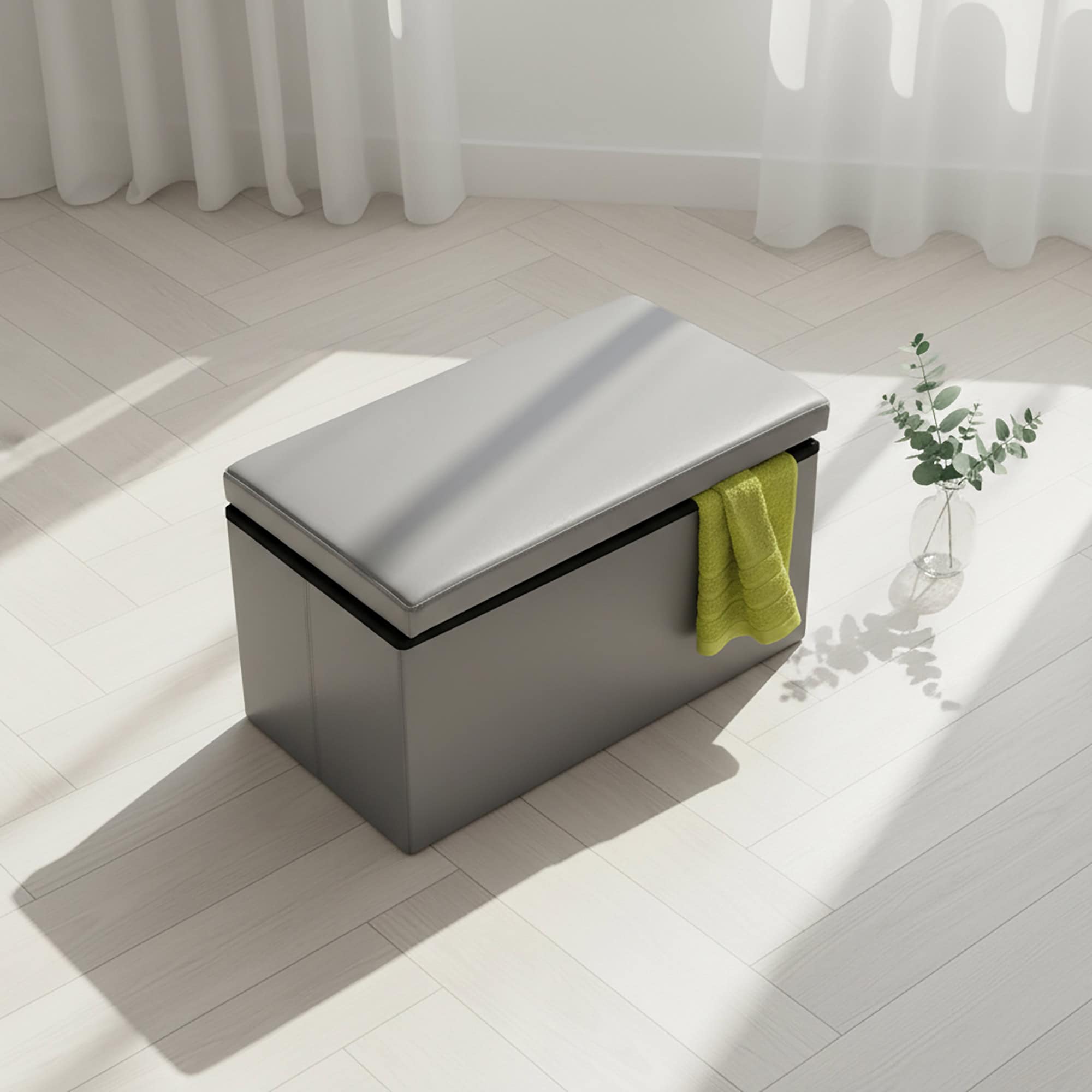 "Gray faux leather folding storage ottoman bench with open lid and yellow towel in sunlit room"