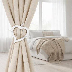"White heart curtain tieback on linen drape in minimalist bedroom"