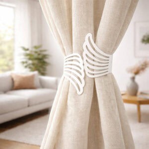 "White metal wings tieback holding cream curtains in a modern living room"