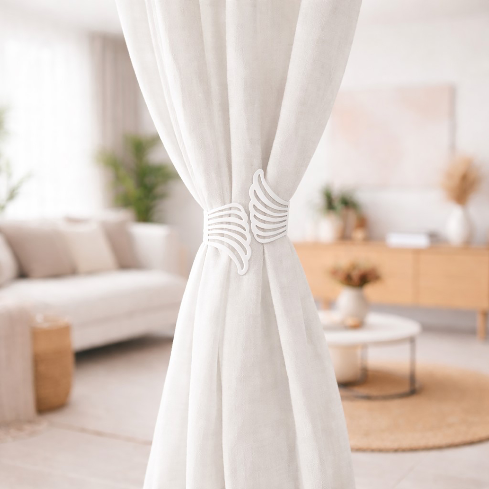 "White angel wings curtain tieback on white drapes in a Scandinavian-style living room"