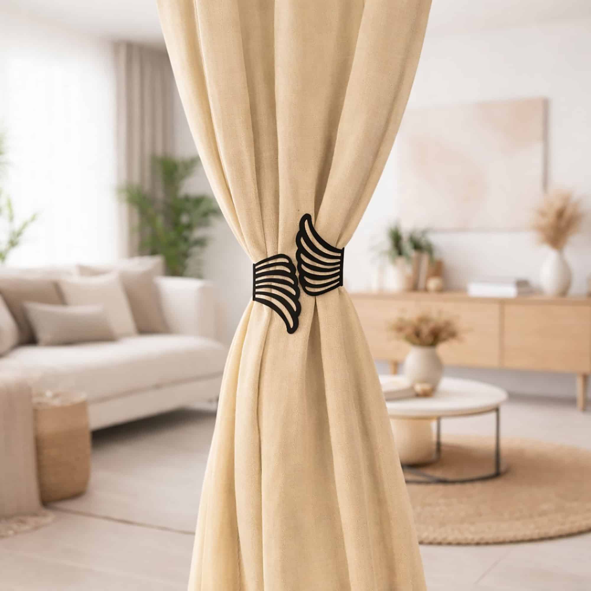 "Black angel wings curtain tieback on beige drapes in a Scandinavian-style living room"