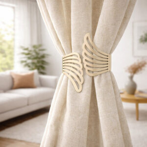 "Gold metal wings tieback holding cream curtains in a modern living room"
