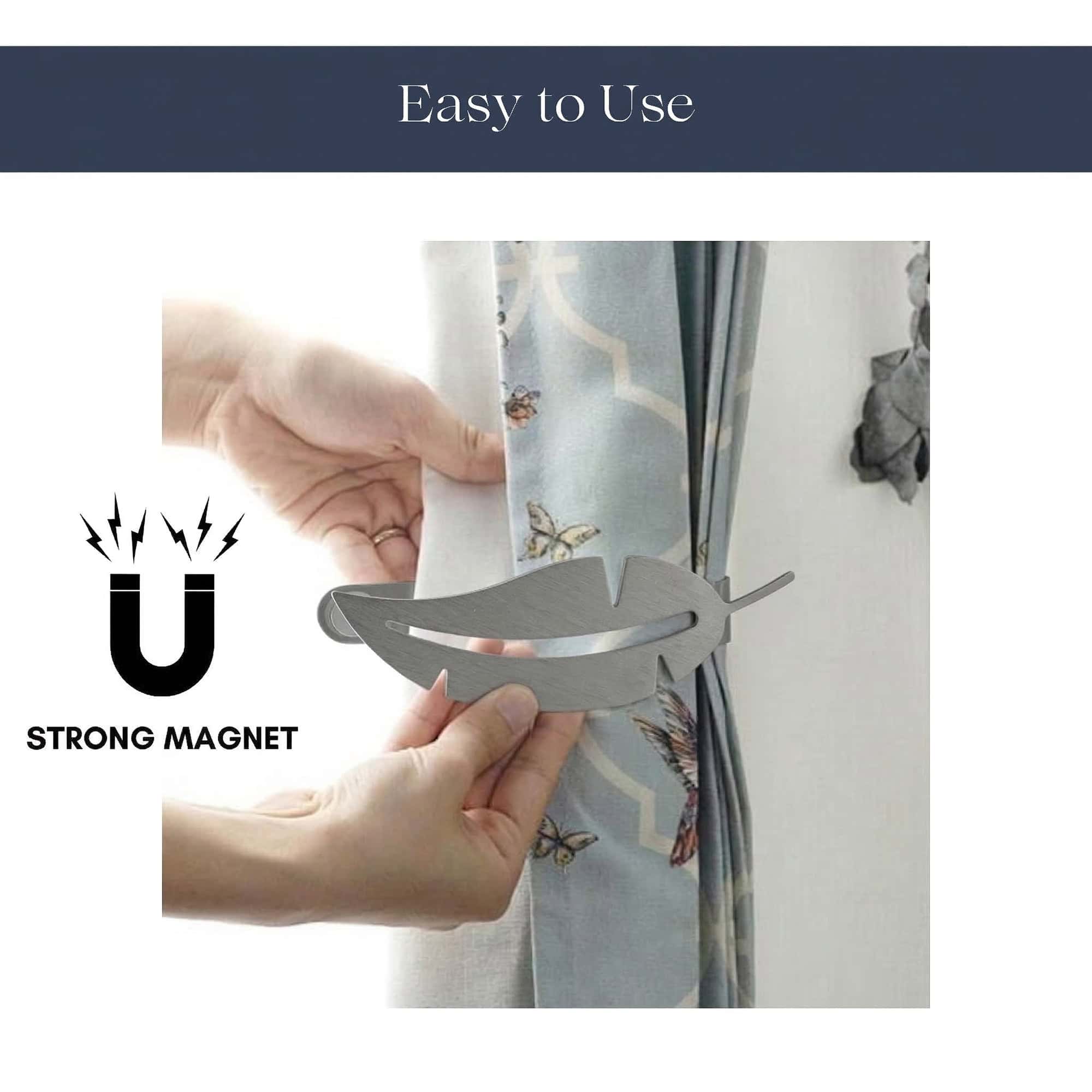 "Hands demonstrating magnetic closure of grey feather curtain tieback"