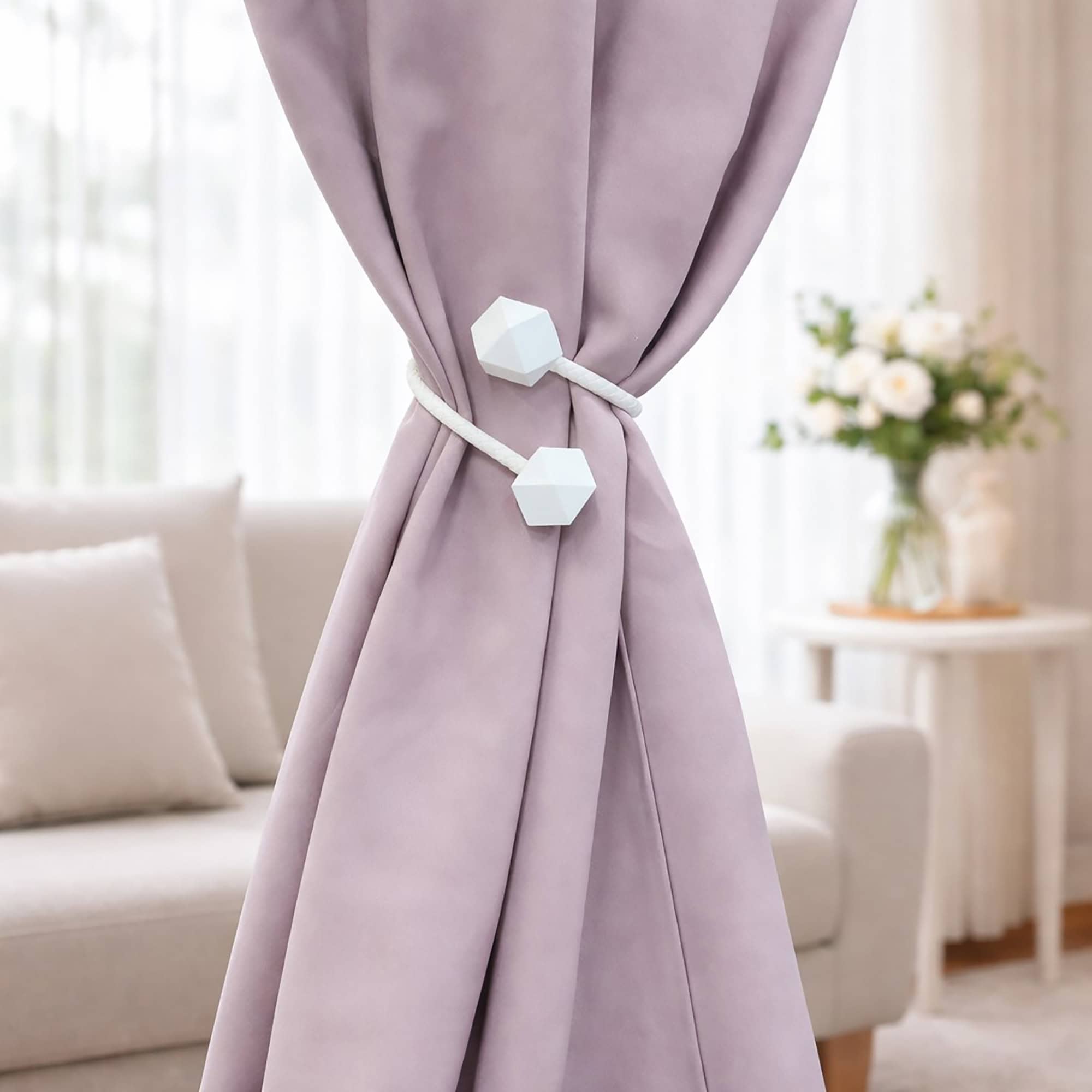 White geometric tieback fastened around mauve curtain, living room setting