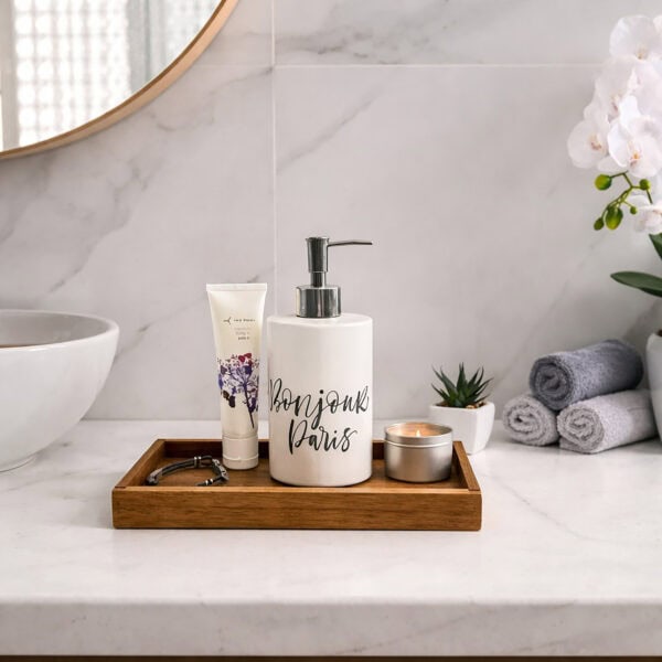 Wooden tray organizing bathroom essentials on marble counter