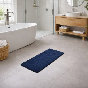 Navy blue memory foam runner mat placed beside bathtub