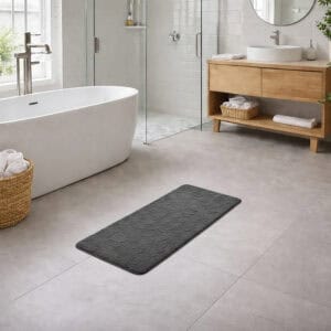 Dark gray memory foam runner mat placed beside bathtub