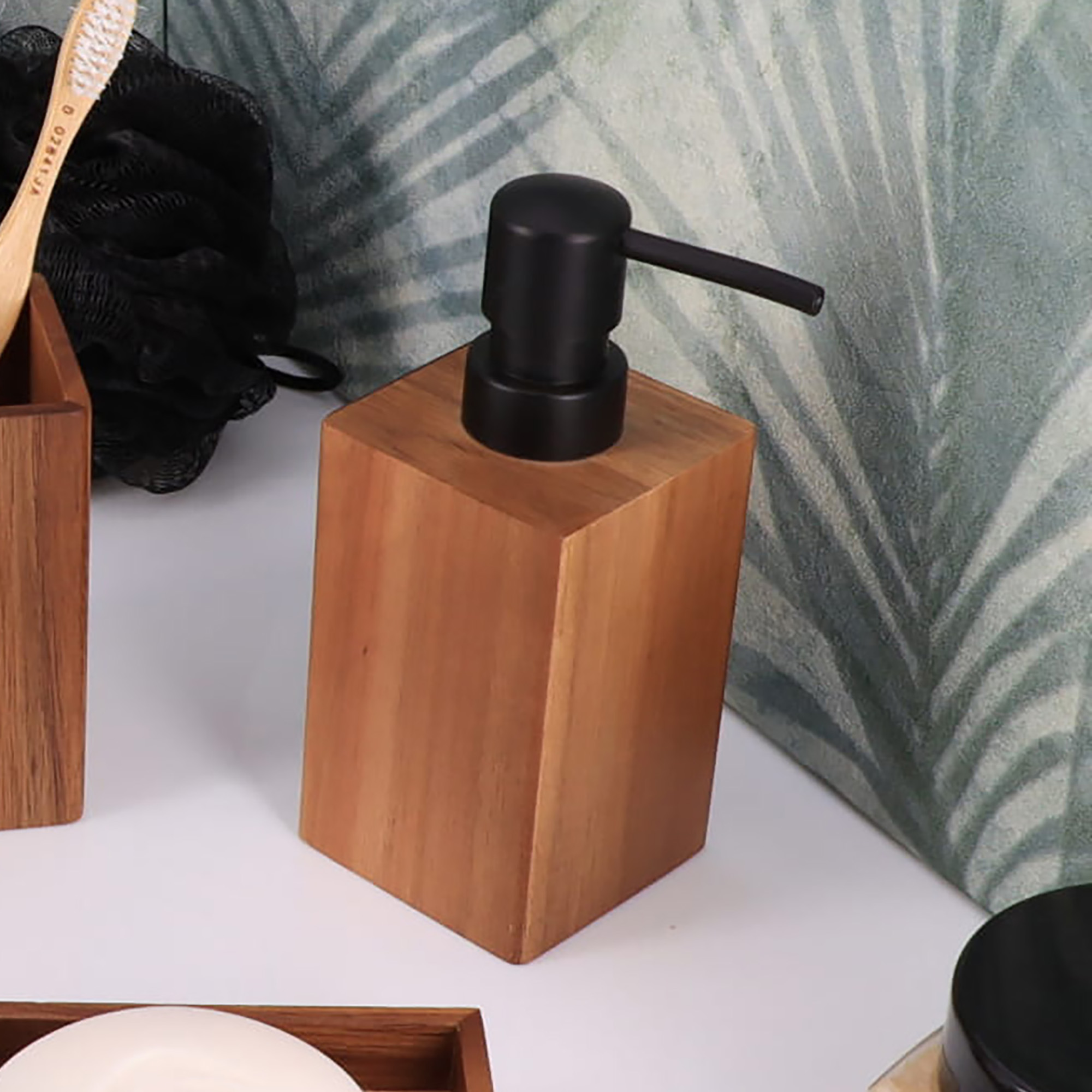 A wooden soap dispenser with a black pump placed on a bathroom counter.