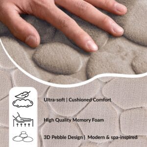 Hand pressing into the soft surface of a taupe runner mat with pebble pattern showing cushioned comfort and memory foam features