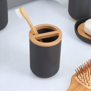 Toothbrush placed inside black bamboo-top holder