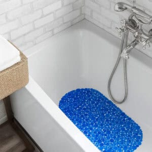 Navy blue pebbles bathtub mat in white tub