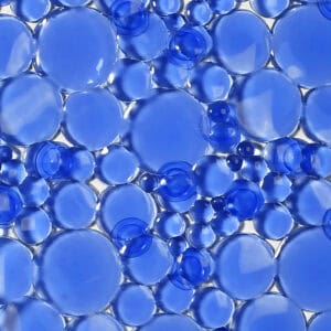 Navy blue pebbles bubbles bathtub mat texture close-up