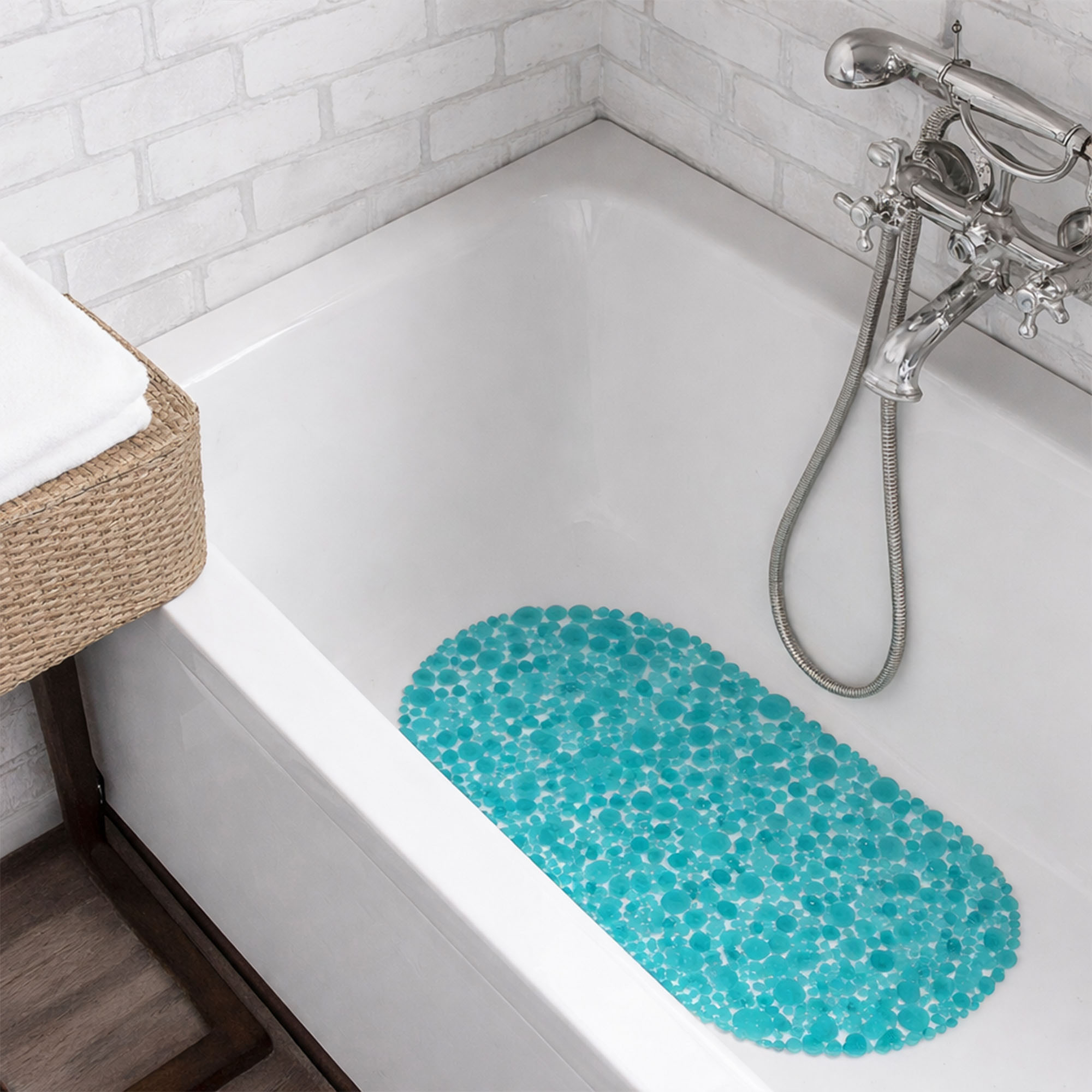Aqua blue pebbles bathtub mat in white tub