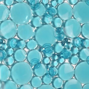 Aqua blue pebbles bubbles bathtub mat texture close-up