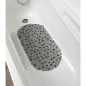 Overhead view of gray pebble-pattern bath mat with visible suction cups in white bathtub