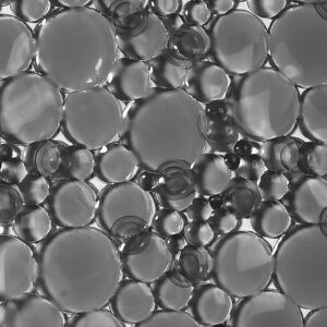 Close-up detail of gray translucent bubble-textured shower mat surface