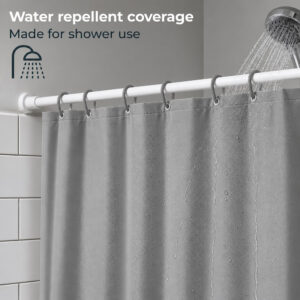 Close-up of a gray polyester shower curtain hung with gray rings on a rod under a running shower head